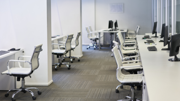 Chairs and computers in shared office space.