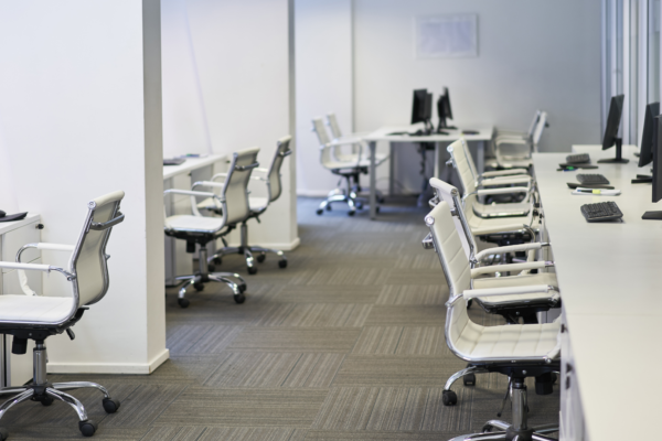 Chairs and computers in shared office space.