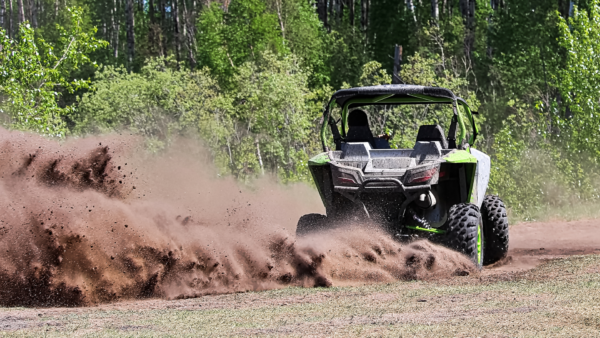 Side-by-side ripping up dirt as it turns the corner.