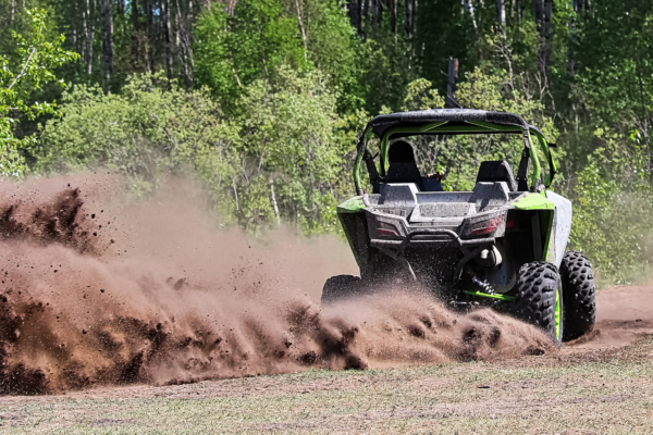 Side-by-side ripping up dirt as it turns the corner.