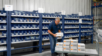 Inventory Technician restocking fasteners in SBS inventory solutions program.